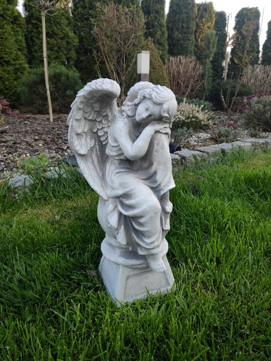Sculpture of resting angel on pedestal 42cm