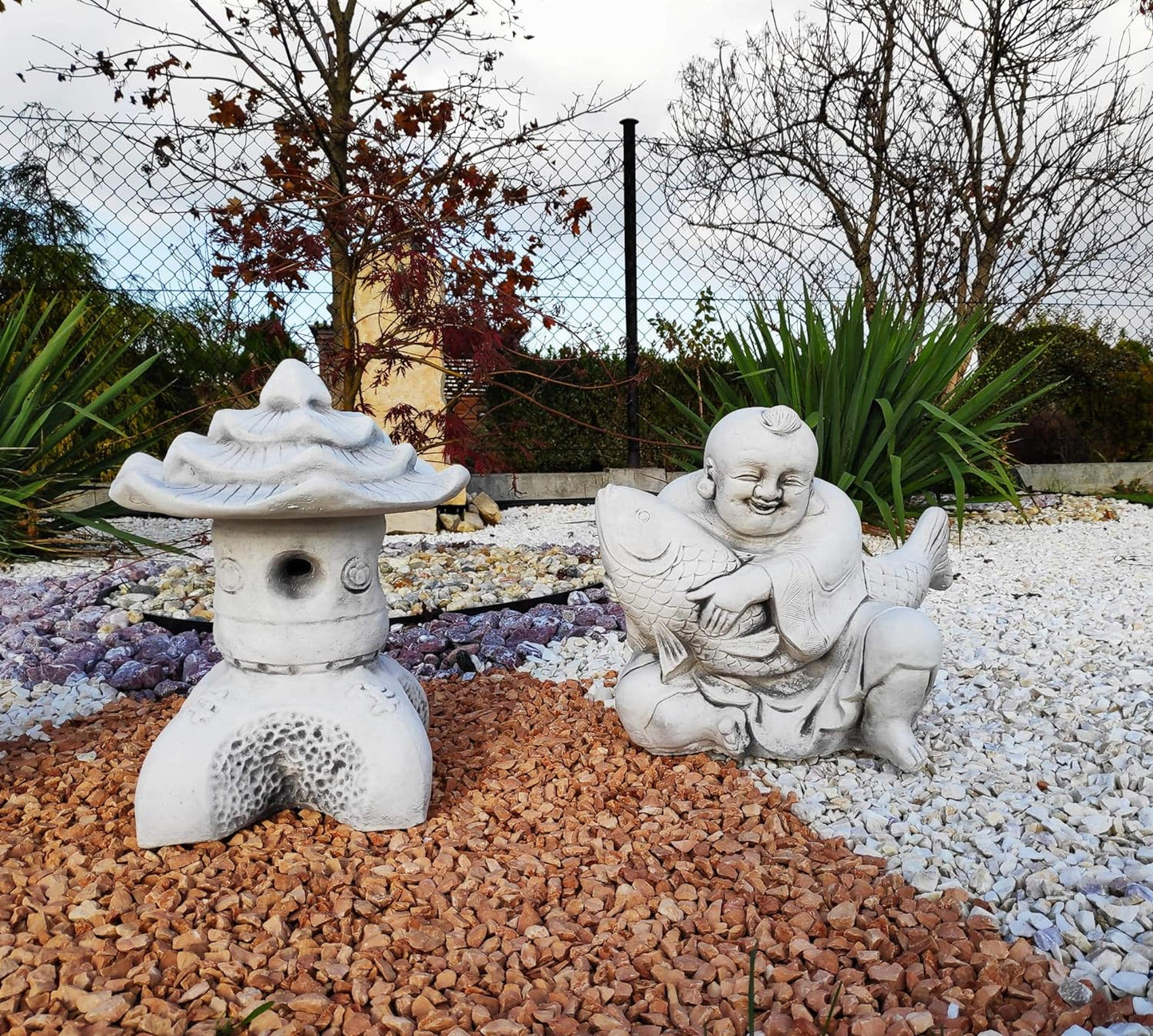 Usmívající se Buddha s rybí sochou prosperity